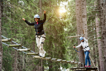 Friends in forest using high rope course