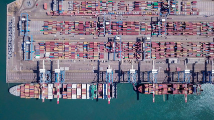 Commercial port with container ships - Top down aerial view.