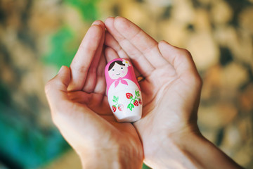 Matryoshka doll in his hands