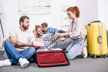 family packing luggage for trip