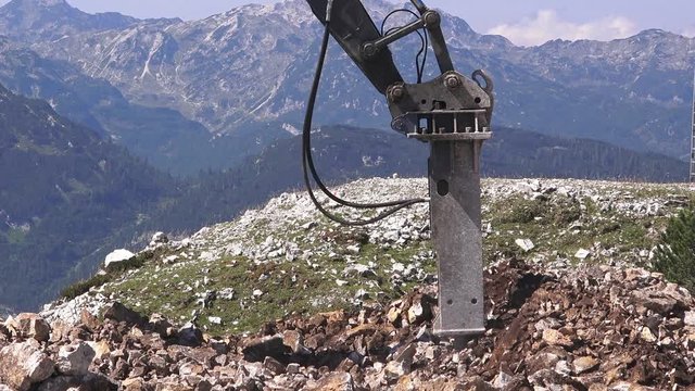 Heavy duty construction industry excavator machine crushing stone on construction site