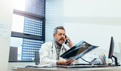 Doctor getting second opinion on patients x-ray