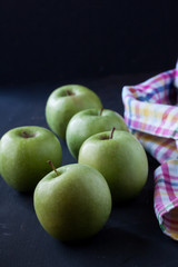 Green apples on a black background