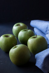 Green apples on a black background