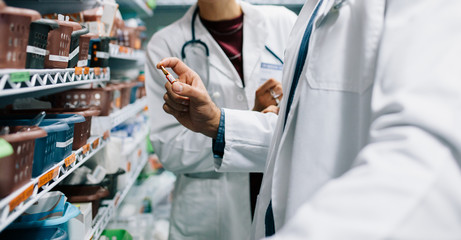Two pharmacist looking for critical medicinal drug