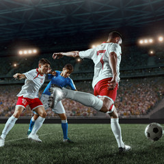 Soccer players performs an action play on a professional stadium. Two football teams fighting for...