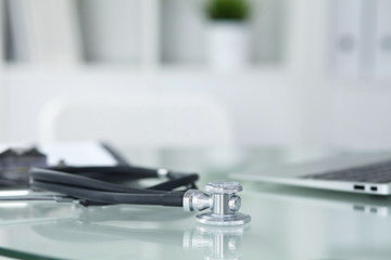 Medicine doctor's working table. Focus on stethoscope 
