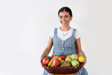 Fototapeta premium woman holding basket with harvest