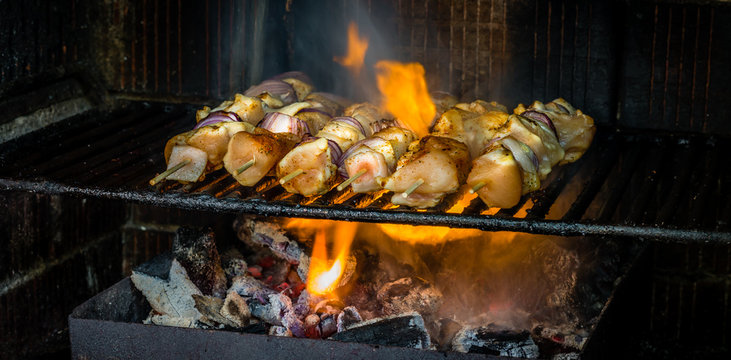 Roasting traditional Romanian dish Frigarui,barbecue, kebab, chicken meat on a skewer in backyard