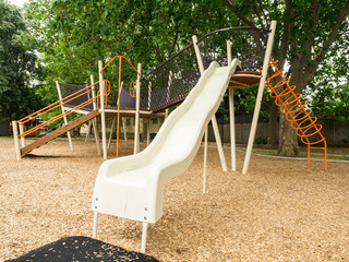 Australian suburban playground with a slide and climbing equipment.