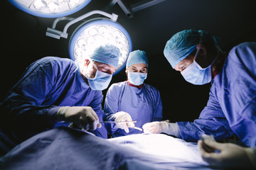 Medical team performing operation in hospital