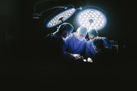 Group of surgeons at work in operation theater.