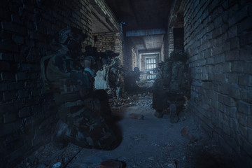 Special Forces soldiers in action. Elite squad sneak up to the enemy in a dilapidated building.They use special equipment, weapons and tactical devices.