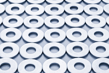 Closeup view of mechanical washers in rows.