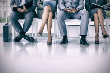 Business people waiting to be called into interview