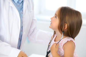 Happy little girl at  health exam at doctor office. Medicine and health care concept