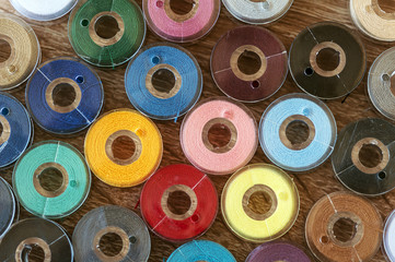 Close-up on colored sewing threads on spools