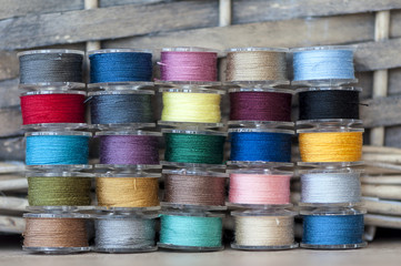 Close-up on colored sewing threads on spools