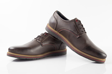 Male brown leather shoe on white background, isolated product.