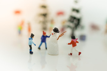 Children enjoy Christmas with snowman.
