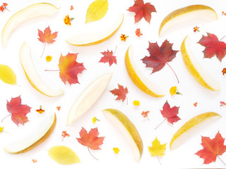 Melon, cut into slices, pattern. Maple leaves on a white background, flat design. Autumn background. Autumn colorful leaves and melon, top view.