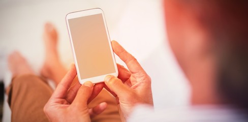 Man using mobile phone in living room