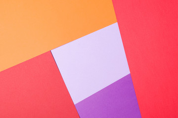 Color papers geometry flat composition background with violet,red, lilac, orange.
