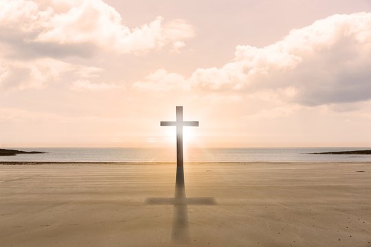 Cross religion symbol shape over sunset sky at the beach - Powered by Adobe