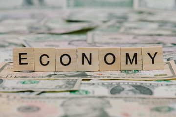 the word "ECONOMY" written in wooden block letters