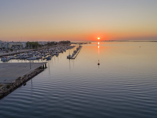 Sunrise aerial seascape view of Olhao Marina, waterfront to Ria Formosa natural park. Algarve.