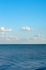 sea horizon with small waves, blue sky with white clouds. Azov of Ukraine.