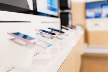 Close up shot of mobile phone in mobile and tablet shop. Selective focus. 