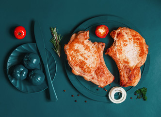 bbq ribeye pork steaks on turquoise cutting board