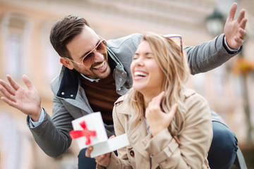 Couple in love.Man surprising his girlfriend with a gift.