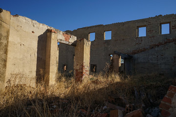 Big wall with windows in ruins.