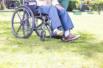 Obraz premium Elderly man on wheelchair outdoor