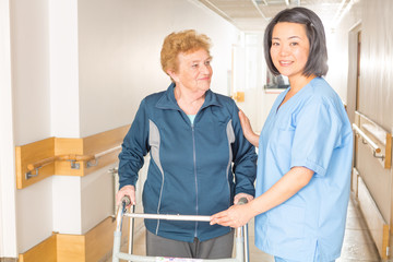 Asian nurse with elder woman patient in hospital