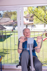 Elderly man working at gym