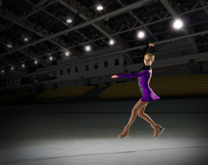Fototapeta na wymiar Girl figure skater in sports hall