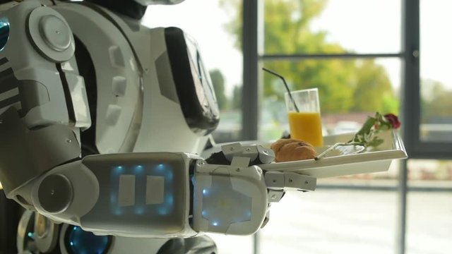 Careful robot carrying tray with breakfast