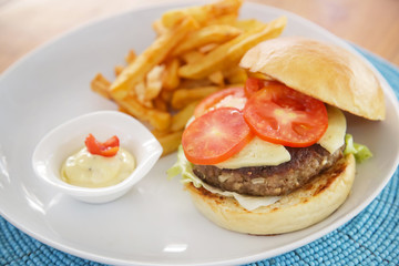 Hamburger and fries served on the restaurant table