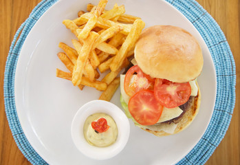 Hamburger and fries served on the restaurant table