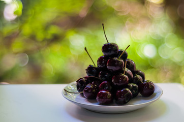 dark purple cherry on white plate