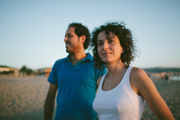 Happy couple on the beach at dawn