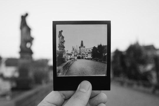 Holding a  Print up on Charles Bridge, Prague