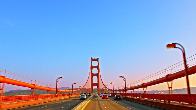 Driving on Golden Gate Bridge, suspension bridge between San Francisco Bay and Pacific Ocean, links peninsula to Marin County, carries Route 101 and California State Route 1, symbol of United States