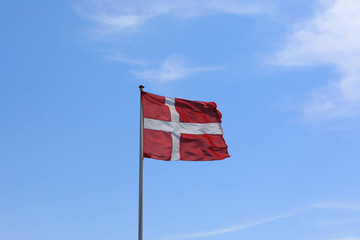 The Danish flag weaves in the wind.