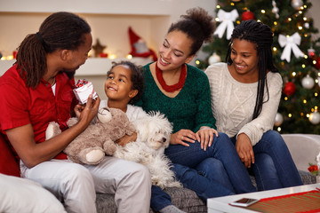 Father giving Christmas preset to his daughter