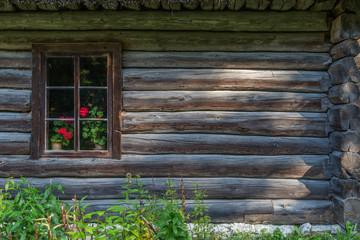 Fototapeta na wymiar The old window of old wooden house. Background of wooden walls