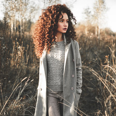 Fashion beautiful lady in autumn landscape
